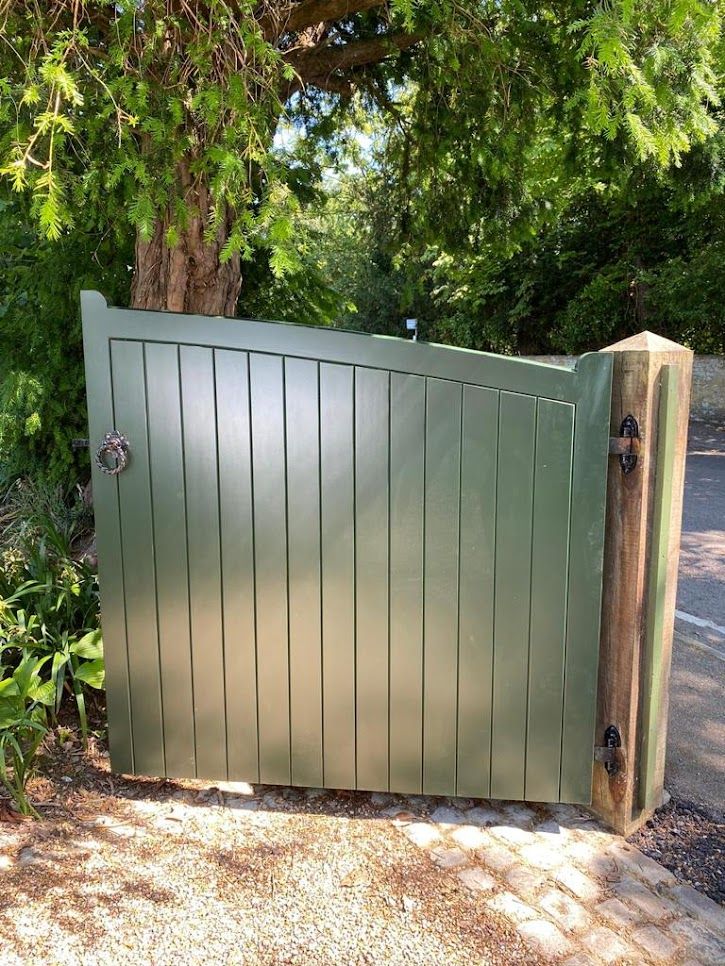 Green painted Accoya timber garden gate with ring latch beside a wooden post