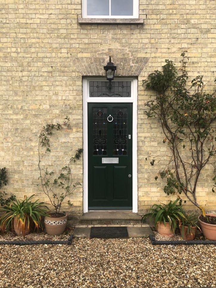 Bespoke dark green entrance door with traditional leaded glass panels