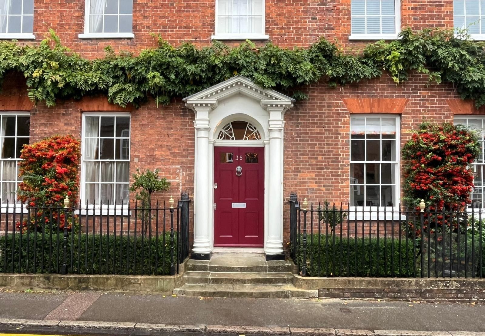 Bespoke burgundy hardwood front door set in brick Georgian townhouse facade