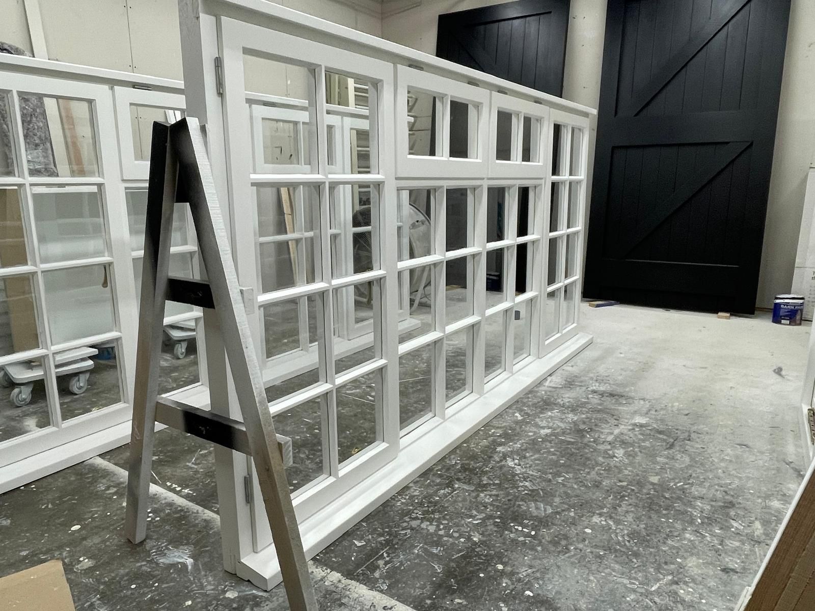 Large white multi-pane timber window unit finished in the workshop