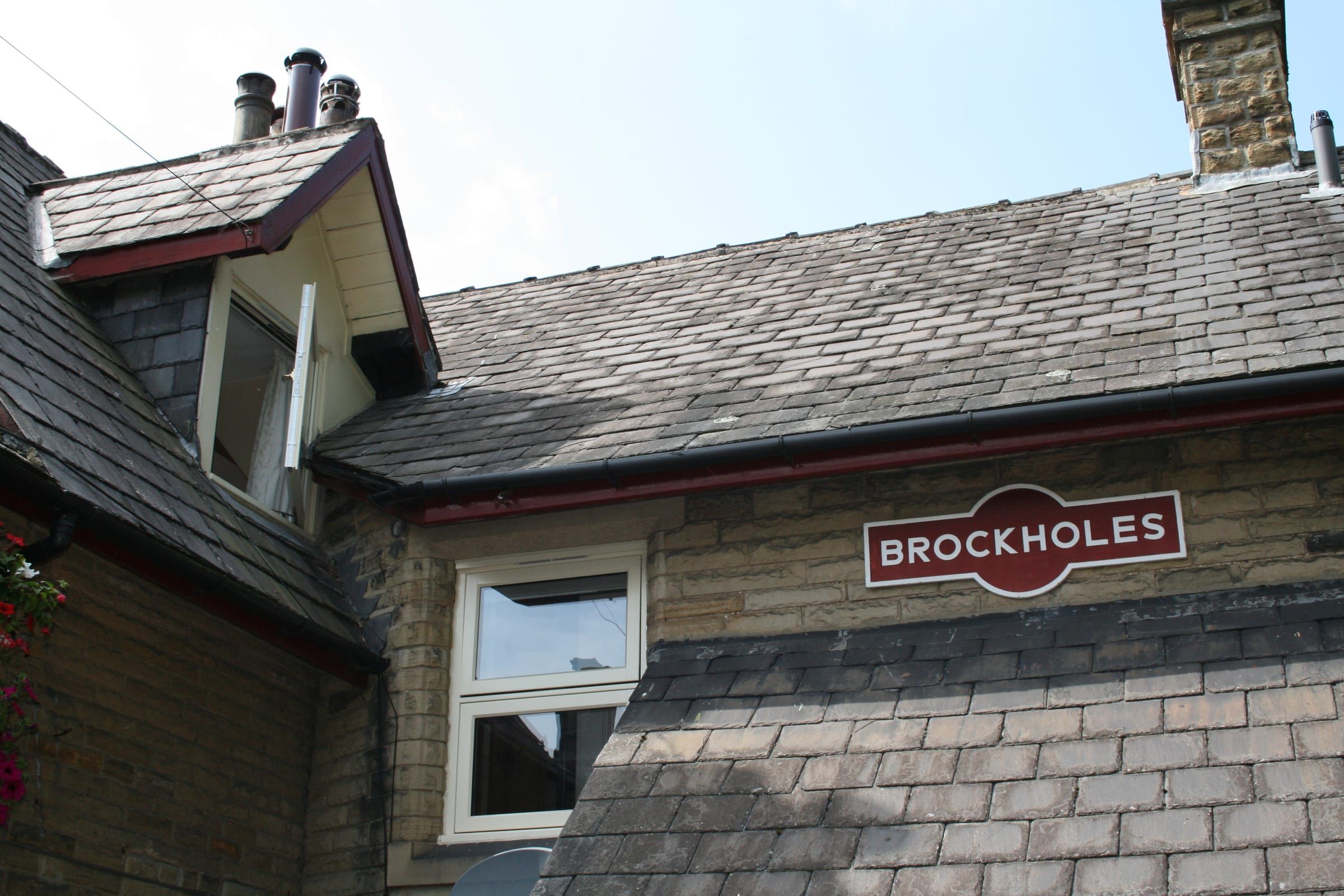 Station roofline with dormer window and Brockholes railway station sign