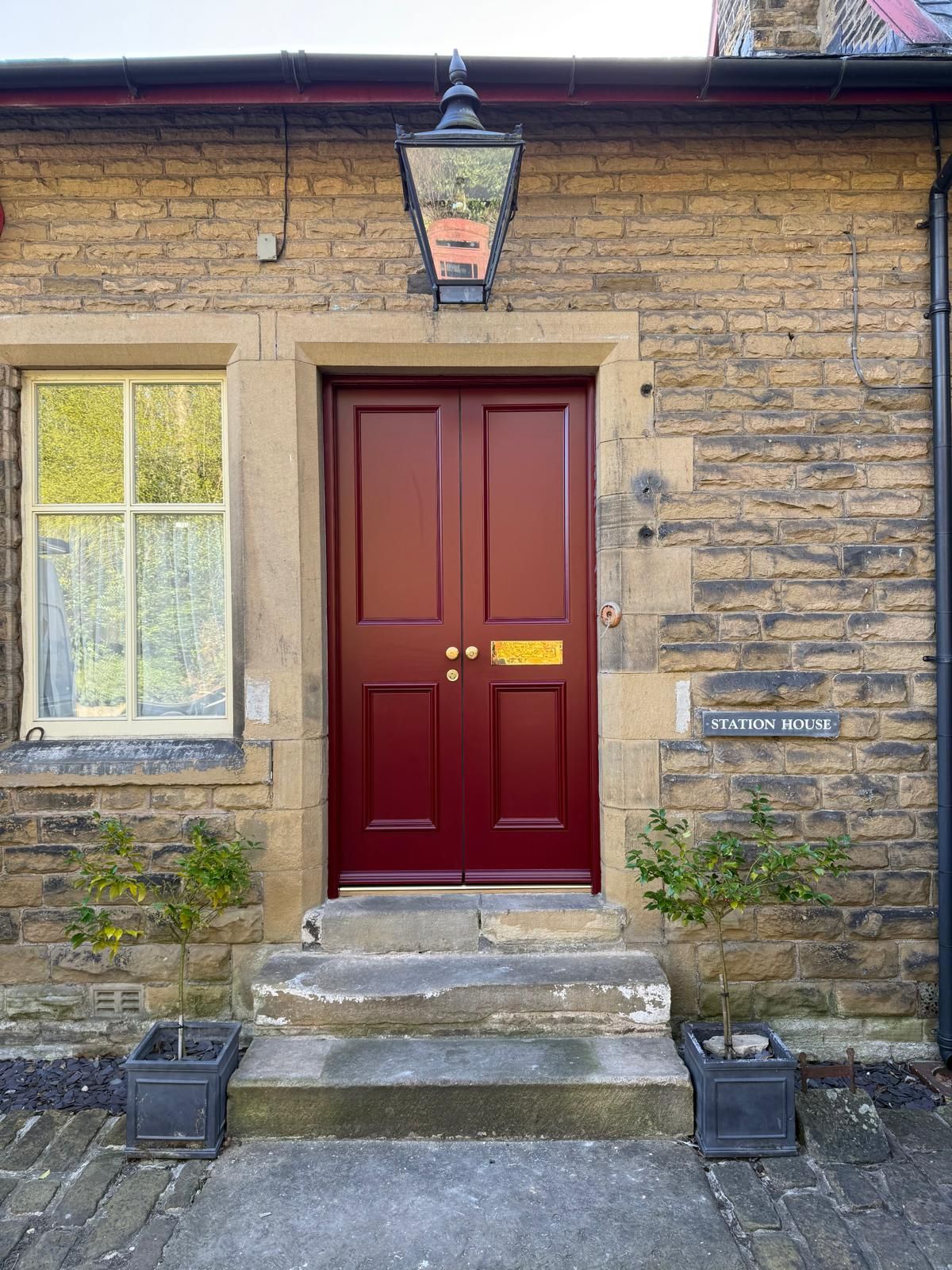 Close-up of new bespoke red Accoya timber front door at Station House