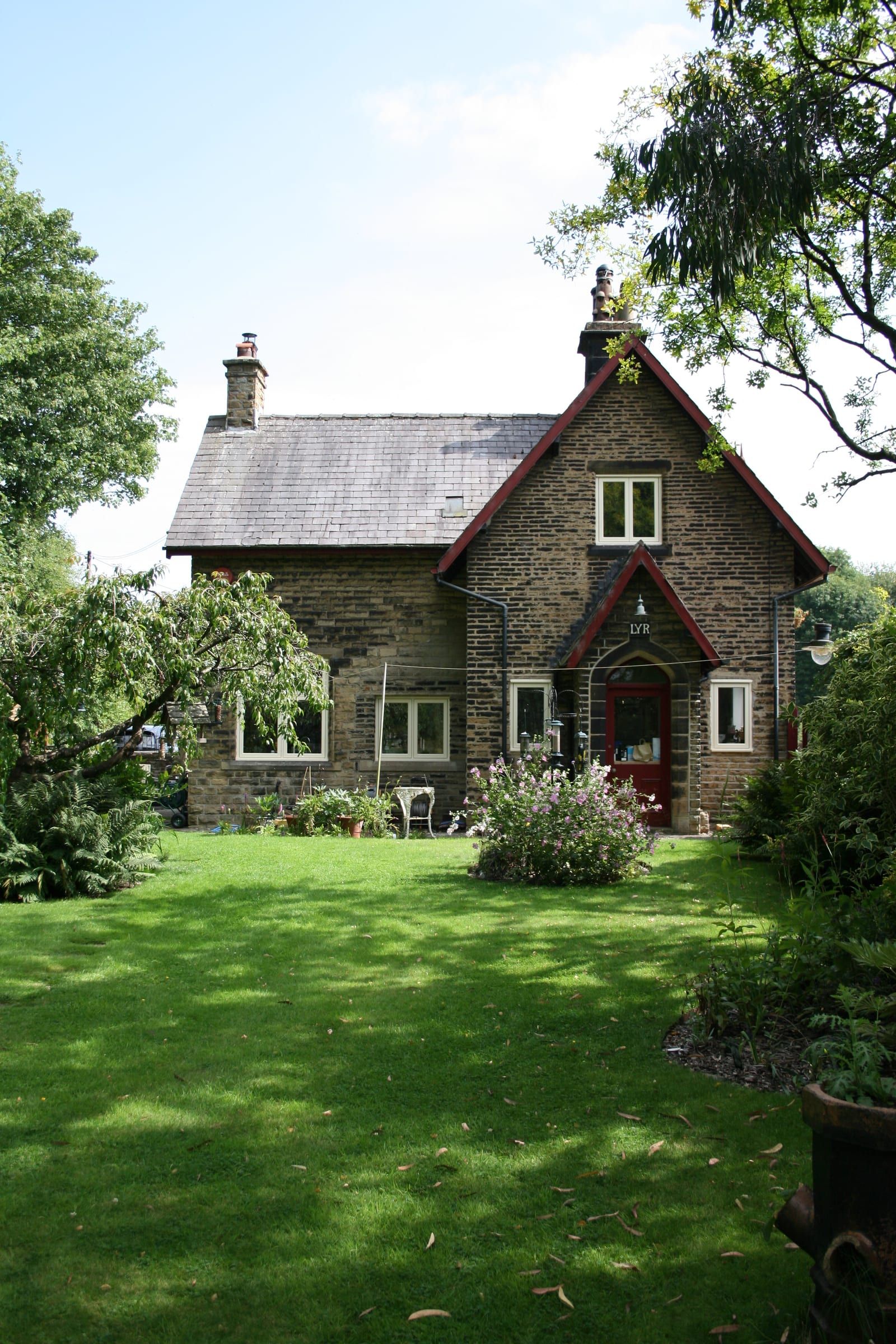 Rear garden view of Station House with red door and new timber windows